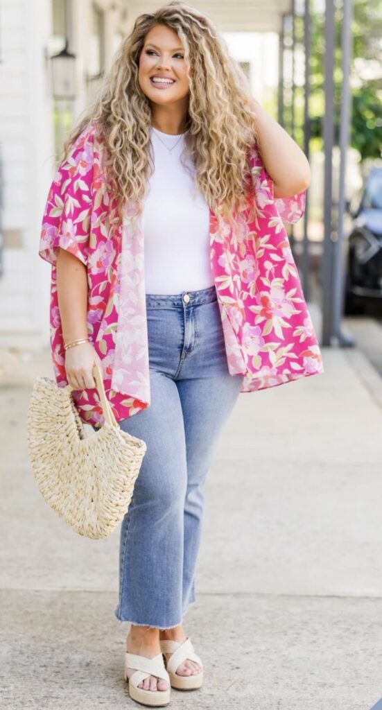Plus size woman layering a printed kimono over a T-shirt and jeans.