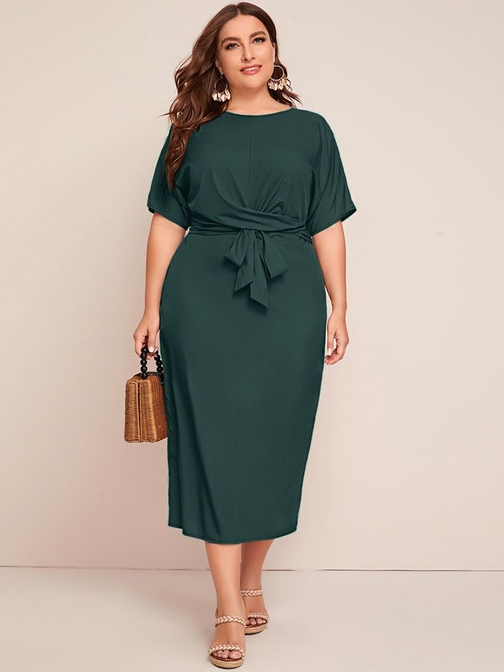 Plus size woman wearing a belted wrap dress that defines the waist for a polished look