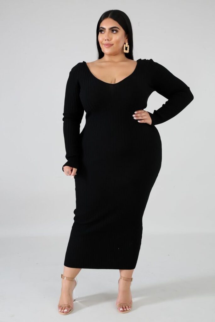 Plus-size woman wearing a black ribbed knit midi dress for a comfortable and polished office outfit.