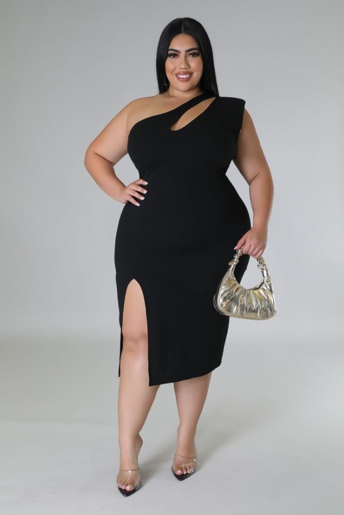 Plus size woman wearing an elegant one-shoulder cocktail little black dress with a thigh slit.