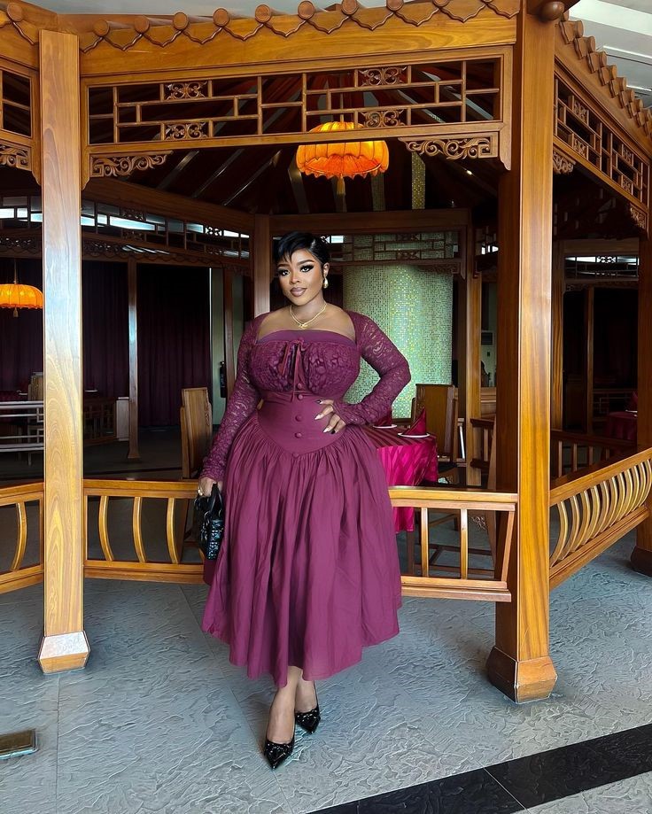 Curvy woman wearing a flattering corset midi dress with a defined waist.