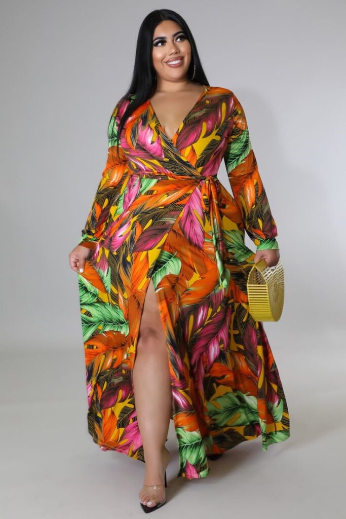 Plus-size woman wearing a colorful tropical print wrap maxi dress to show how to wear bold prints with confidence.