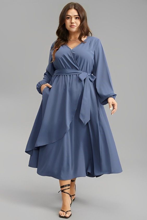 Plus size woman wearing a long sleeve wrap dress with heels