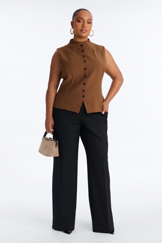 Curvy woman wearing a sleeveless mock-neck top with wide-leg trousers for a polished business casual office outfit
