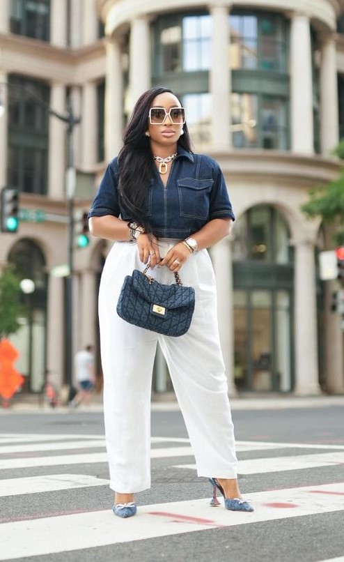 Plus-size woman wearing a navy top with white trousers, showing a timeless and flattering color combination for a polished everyday look.
