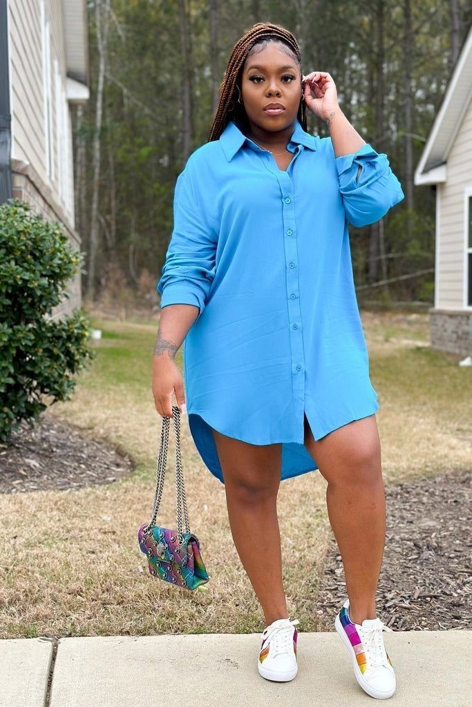 Plus size woman wearing an oversized shirt dress with sneakers for a casual weekend outfit