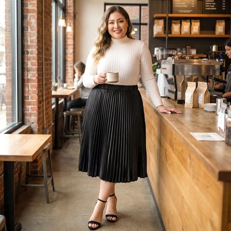 Plus size woman wearing a pleated midi skirt with a fitted top for an elegant outfit.