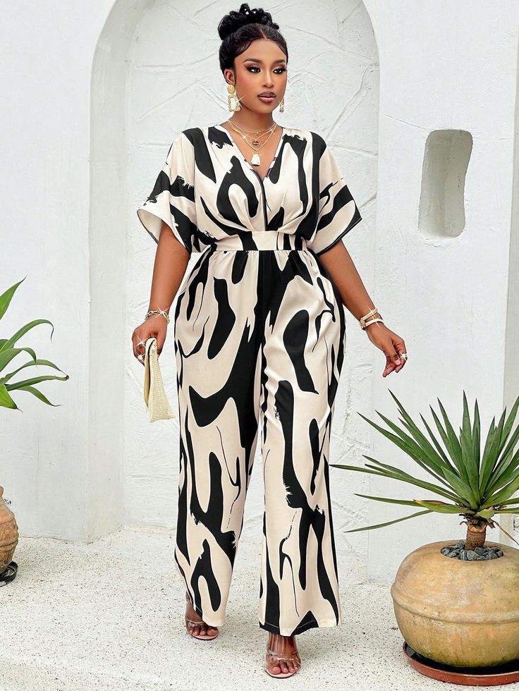 Plus-size abstract print jumpsuit showing how to wear bold prints with confidence using a neutral color palette.