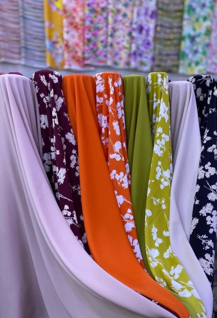 Different fabrics used in plus size maxi dresses, including satin, cotton, and knit.