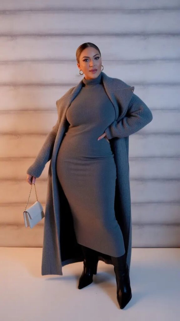 Plus size woman wearing a monochrome gray winter outfit with a knit dress and long coat