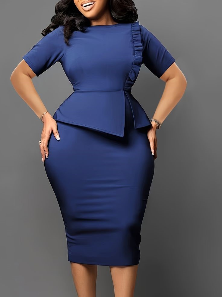 Plus size woman wearing a structured peplum dress for a polished outfit.