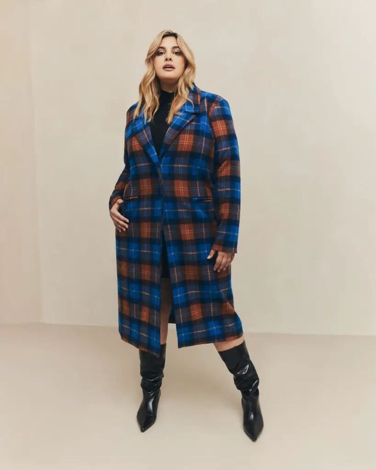Plus size woman wearing a plaid coat with neutral layers for a stylish winter outfit