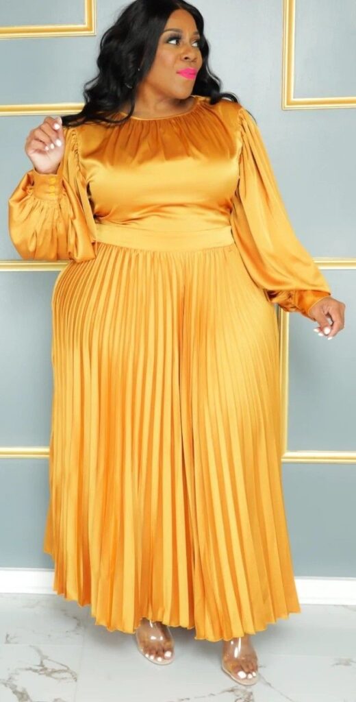 Elegant plus size pleated maxi dress with a flowing floor-length skirt.