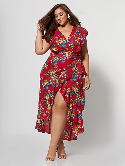 Plus-size woman wearing a red floral wrap midi dress with nude heels and floral earrings.