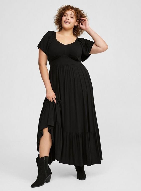 Plus size tiered maxi dress with flutter sleeves and a flowing floor-length skirt.