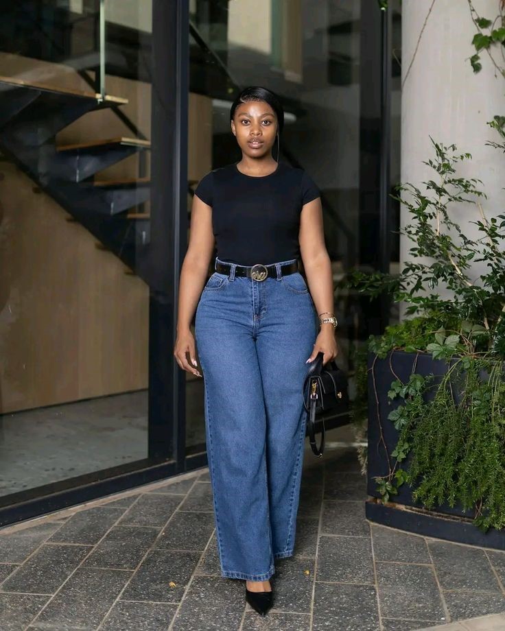 Plus-size woman wearing wide-leg jeans with a fitted bodysuit