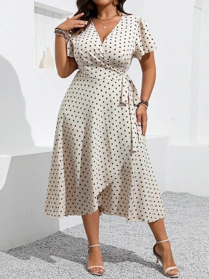 plus size woman wearing a playful polka dot wrap dress for a casual daytime outfi