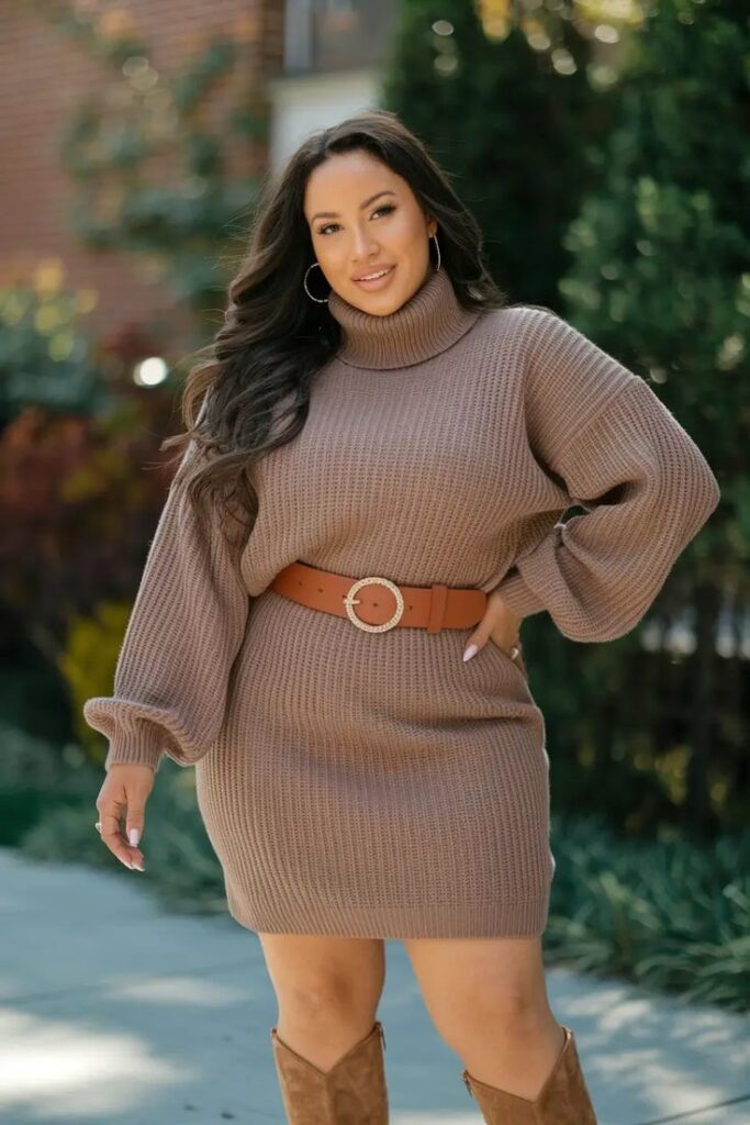 Woman wearing a ribbed sweater dress with knee-high boots for a chic and cozy fall outfit idea.