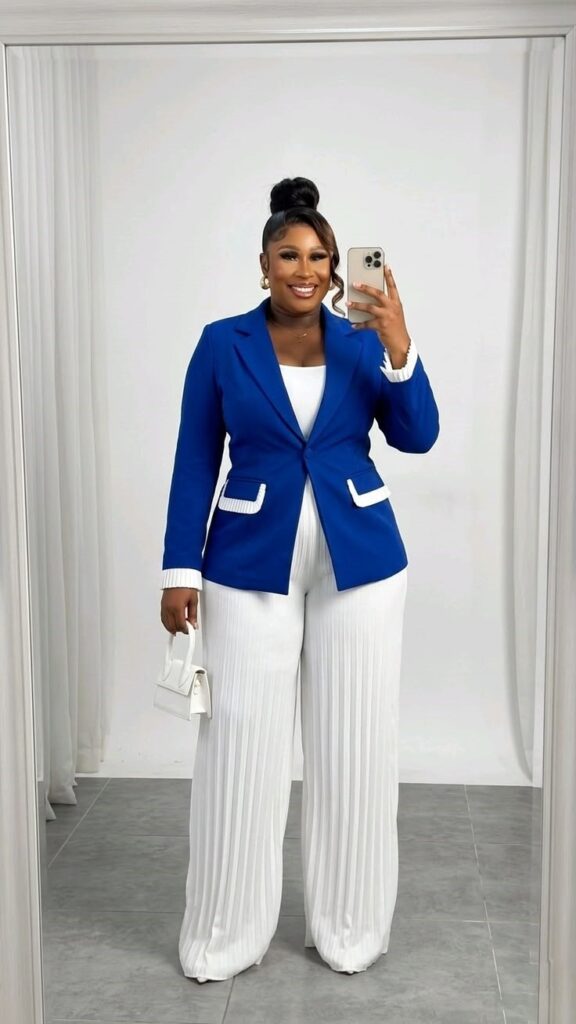 Plus-size woman wearing a royal blue blazer with white wide-leg trousers, demonstrating a classic blue and white color combination