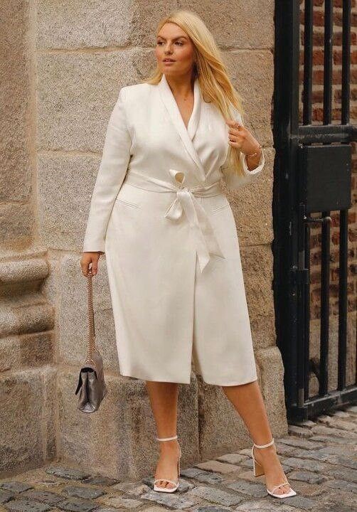 Curvy woman wearing a belted shirtwaist midi dress for work.
