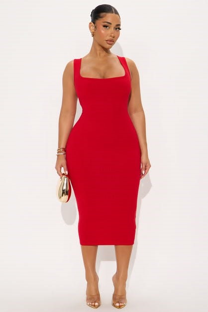 Curvy woman wearing a square-neck midi dress with delicate layered jewelry.