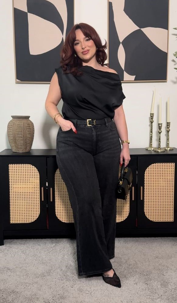 Plus size woman wearing straight-leg trousers with an elegant off-the-shoulder top and block heels.