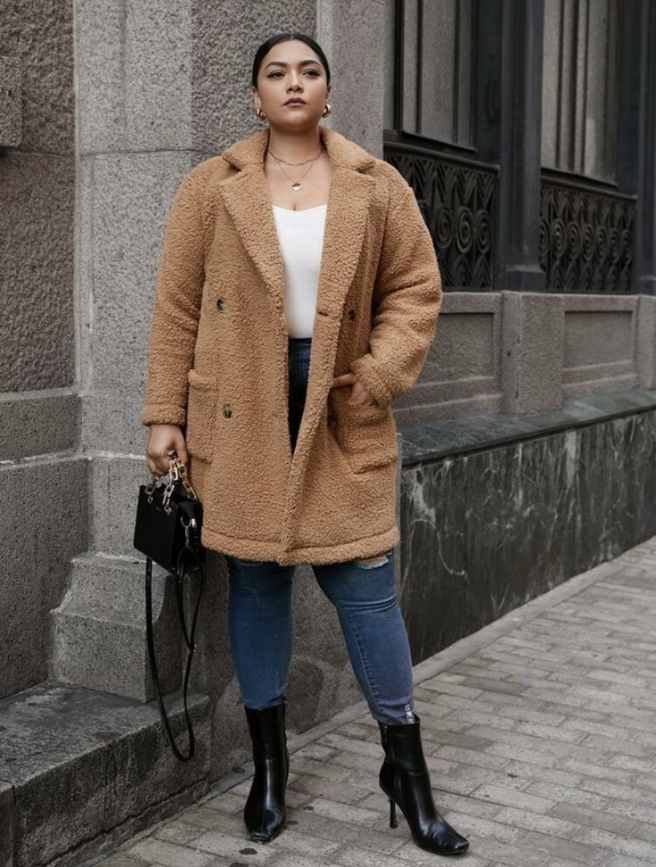 Woman wearing a camel teddy jacket with jeans and ankle boots for a cozy fall outfit idea.