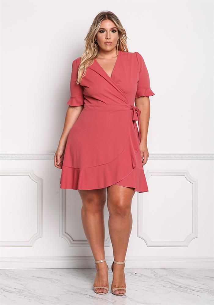curvy woman wearing a V-neck wrap dress with a flattering crossover neckline and waist tie.