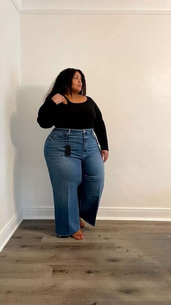 Plus size woman wearing wide-leg jeans with a fitted bodysuit for a flattering look.