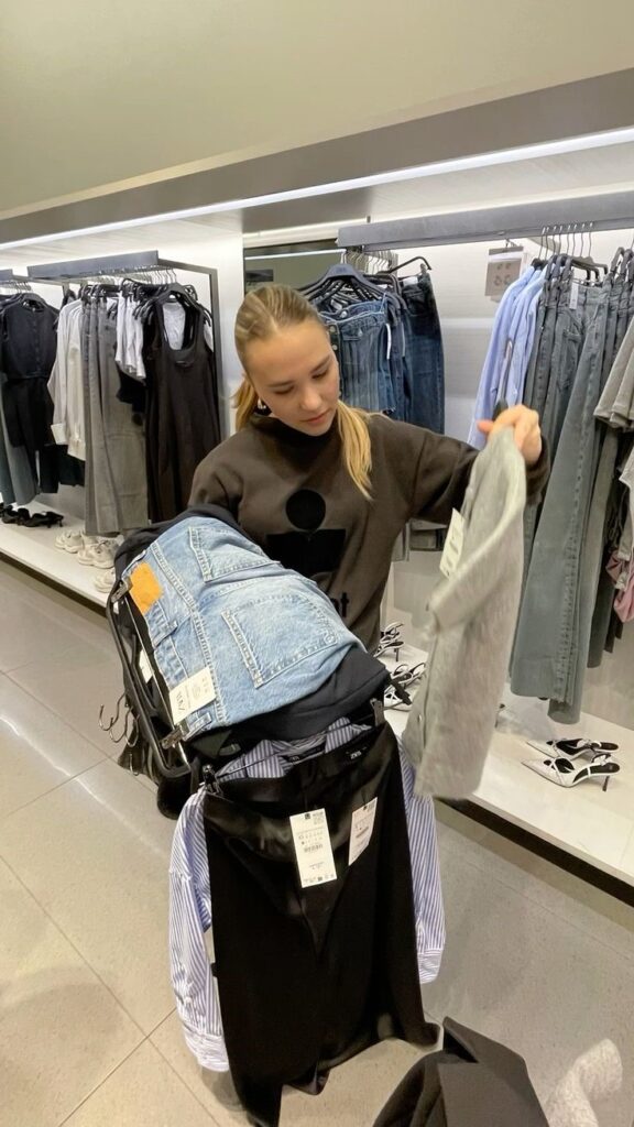 Woman shopping for trendy clothing in a modern fashion store