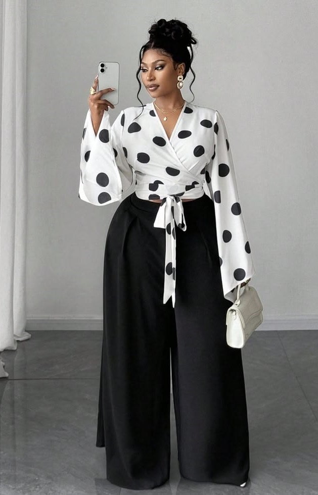 Plus-size woman wearing a wrap blouse with wide-leg trousers for a comfortable office outfit.