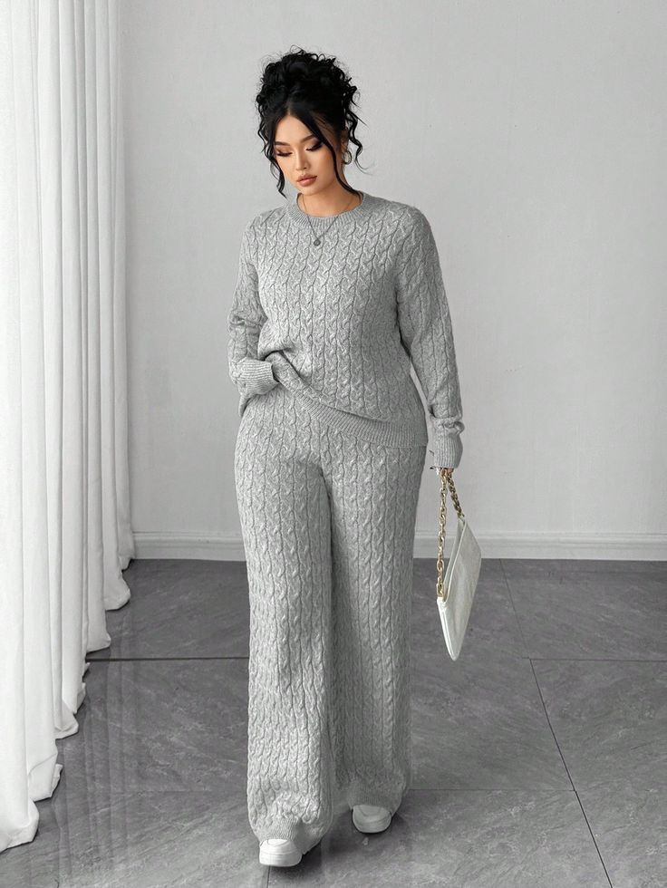 Woman wearing a matching grey knit top and wide-leg trousers