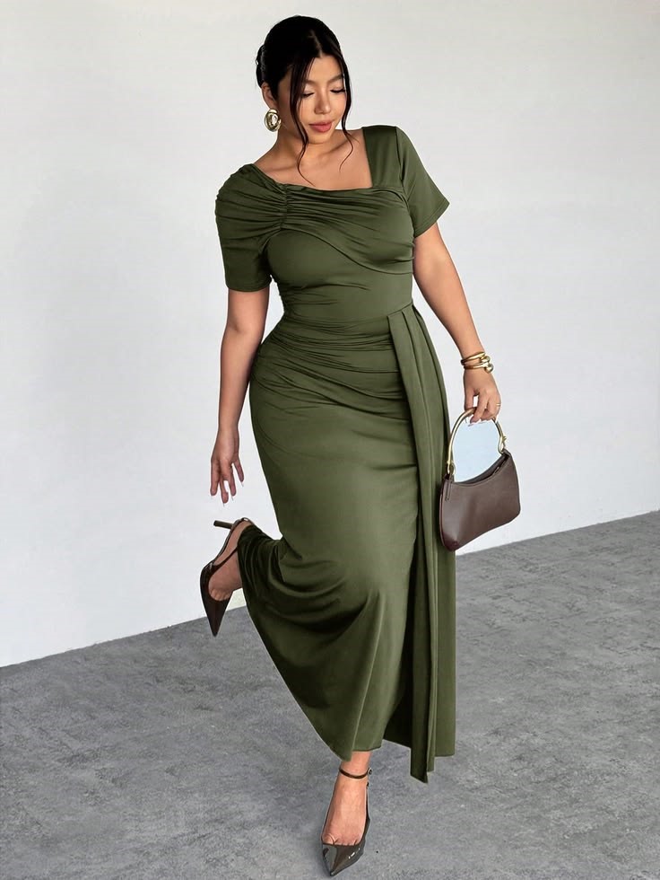 Plus size woman wearing an olive green maxi dress with heels and a brown handbag