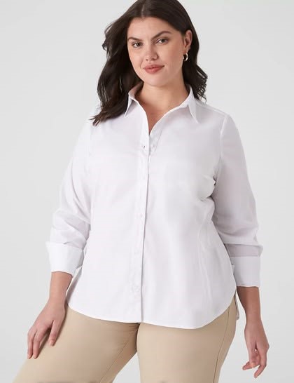 Plus size woman wearing a classic white button-down shirt with beige trousers