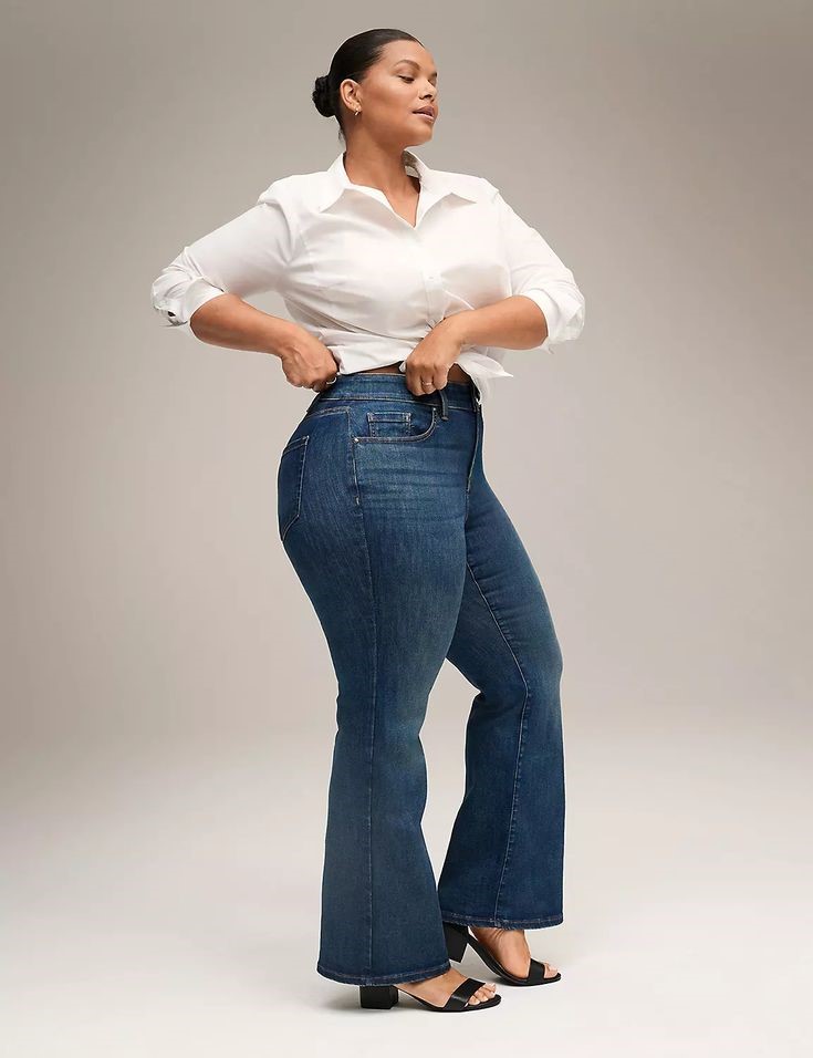 Curvy woman wearing high-rise bootcut jeans with a white shirt