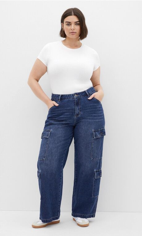 Woman wearing blue cargo jeans with a white T-shirt and sneakers