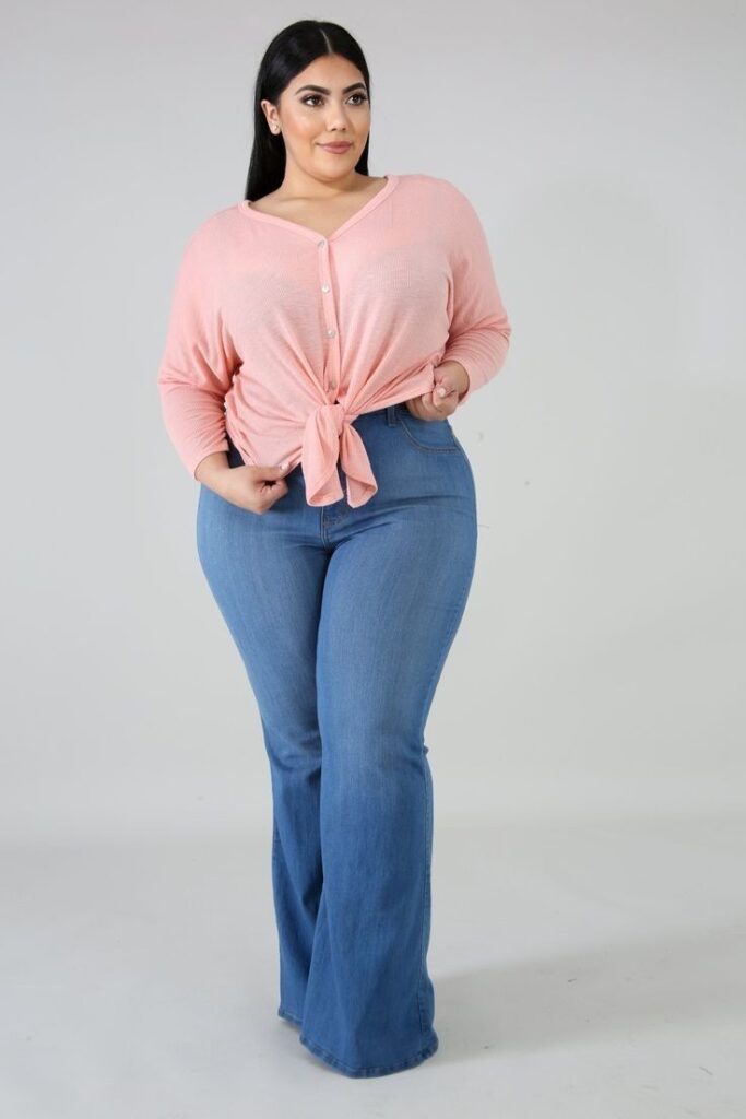 Plus size woman wearing light wash jeans with a fitted curvy silhouette
