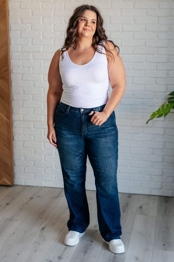 Plus size woman wearing dark-wash mid-rise straight-leg jeans