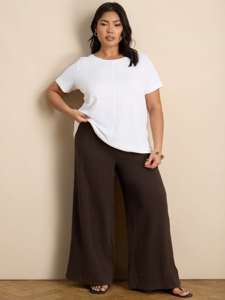 A woman wearing comfortable everyday trousers with a white T-shirt 