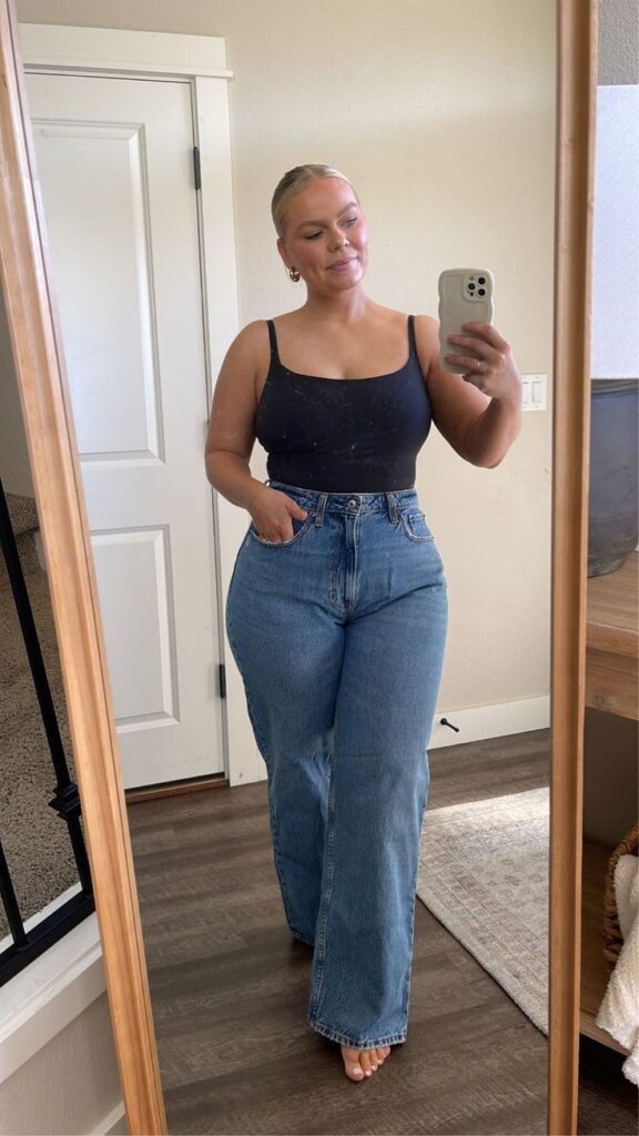 Curvy woman checking how wide-leg jeans fit her body shape