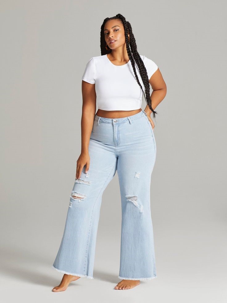 Plus size woman wearing high-rise wide-leg jeans with a white top
