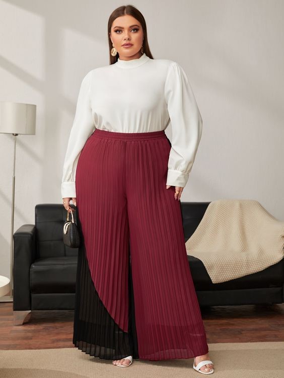 High-waisted burgundy pleated trousers flattering for an inverted triangle body shape