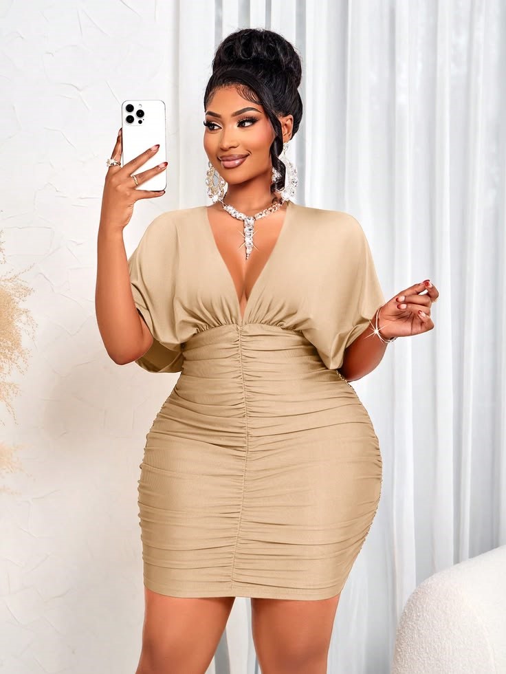 Hourglass plus size woman wearing a waist-defining dress that follows her natural curves