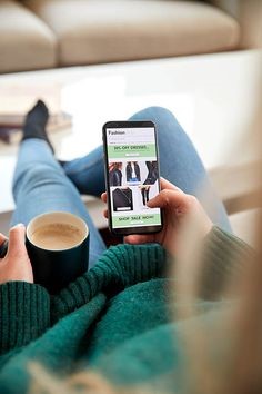 Woman shopping for jeans and clothing online on her phone