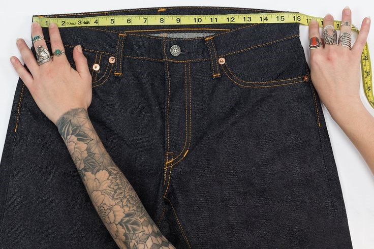 Measuring the waistband of a pair of well-fitting jeans with a tape measure