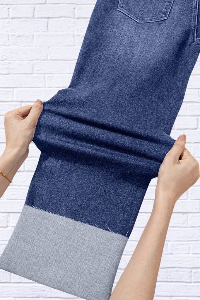 Stretch denim fabric being pulled to show its flexibility