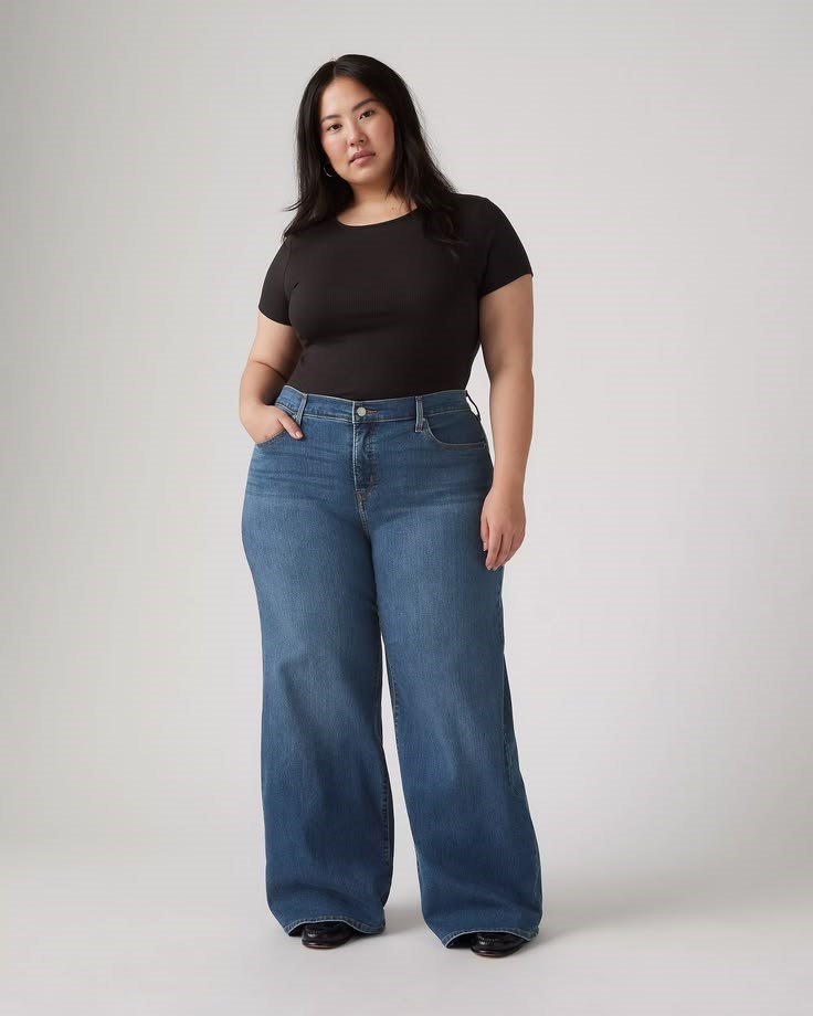 Plus size woman wearing wide-leg jeans in a relaxed silhouette