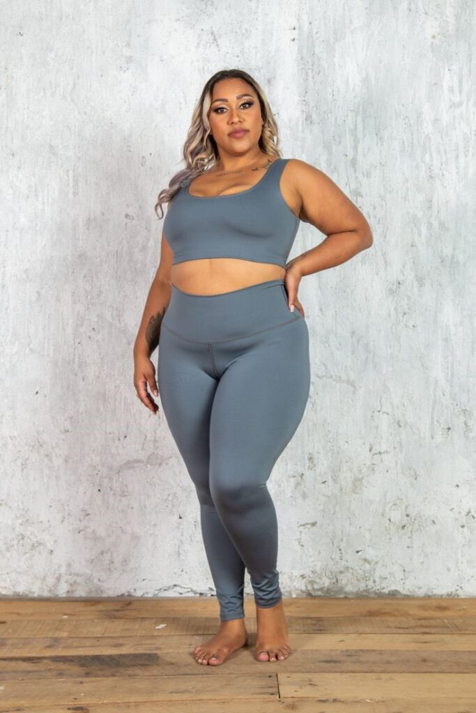 Plus-size woman with an inverted triangle body shape showing shoulders wider than hips