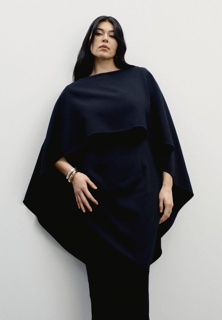 Woman wearing a structured 11 Honoré black cape dress