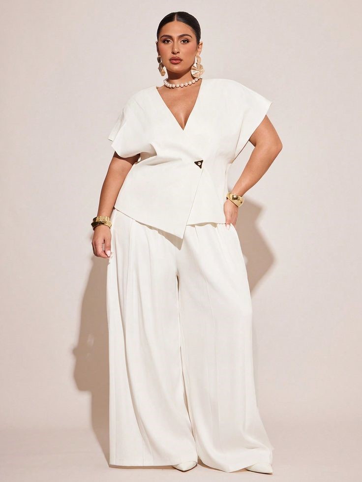 Plus-size woman  wearing a V-neck top and wide-leg trousers for a balanced silhouette.
